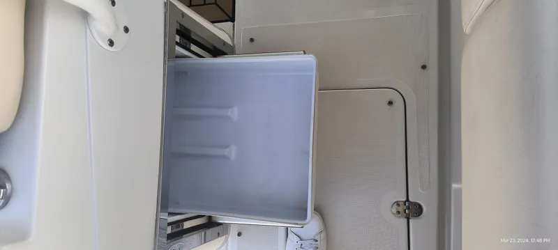 Slide: The Image of 2015 Chris-Craft Catalina 29 interior storage compartment with open drawer. - 20