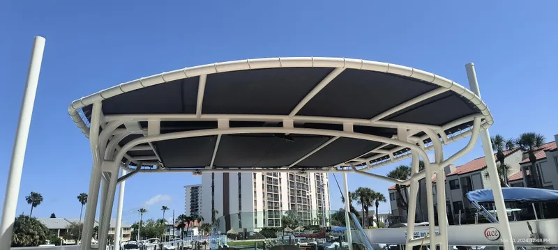 Slide: The Image of 2015 Chris-Craft Catalina 29 boat canopy with marina and buildings in the background. - 23