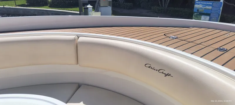 Slide: The Image of 2015 Chris-Craft Catalina 29 boat with beige seating and wooden deck. - 25
