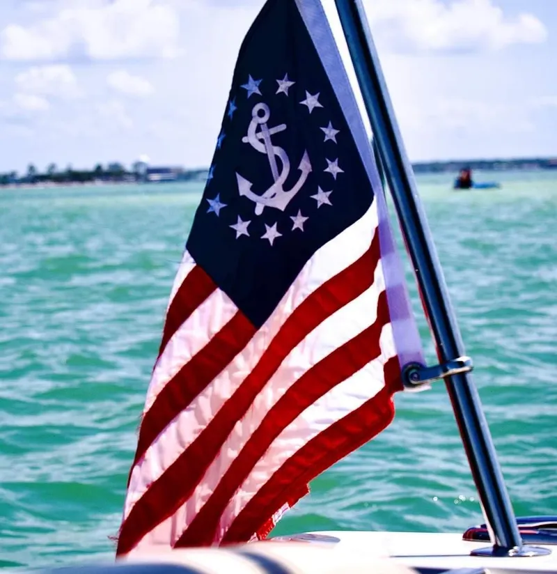 Slide: The Image of American flag on a 2015 Chris-Craft Catalina 29 boat in open water. - 29