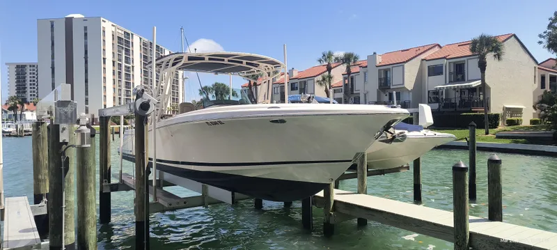 Slide: The Image of 2015 Chris-Craft Catalina 29 boat docked in a marina with waterfront homes. - 3