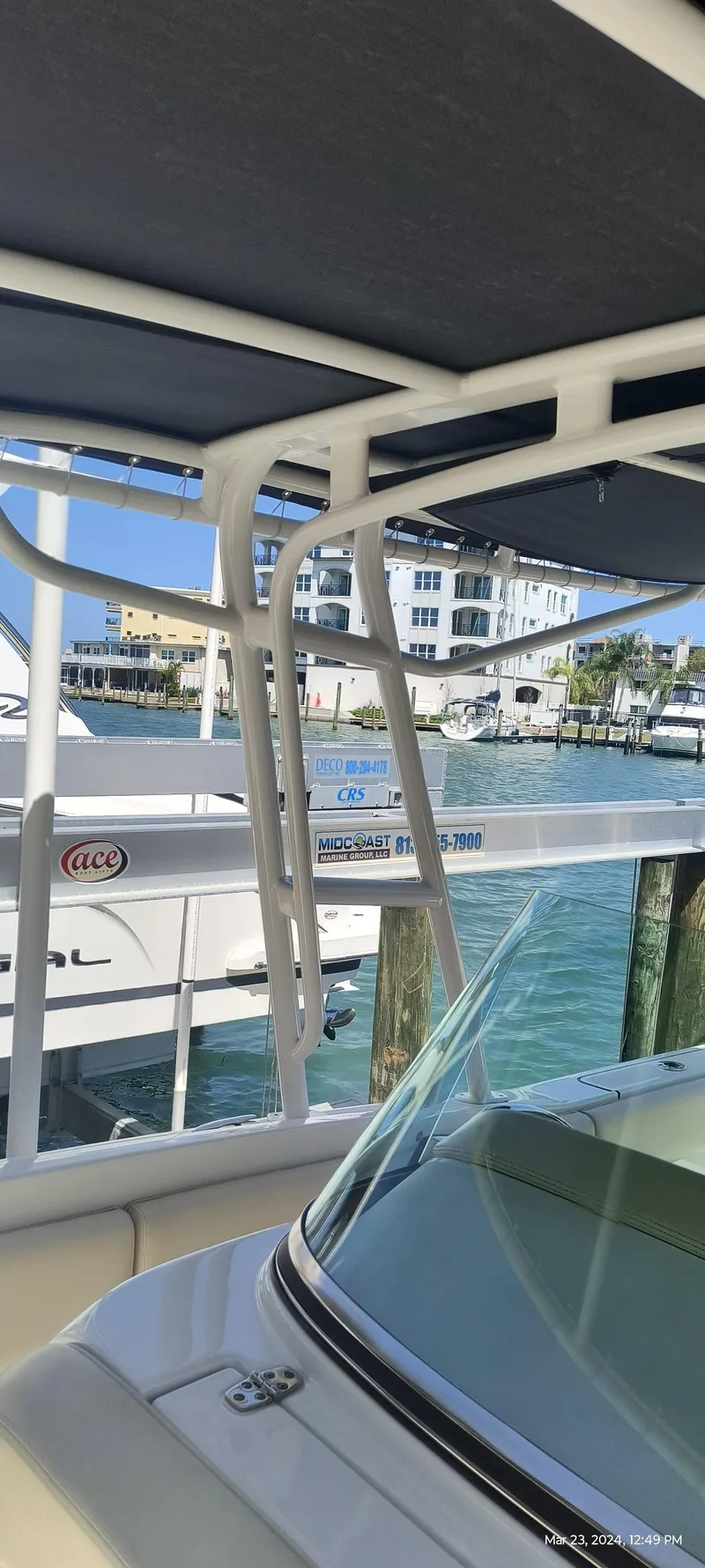 Slide: The Image of 2015 Chris-Craft Catalina 29 boat docked at a marina with a view of nearby buildings. - 33