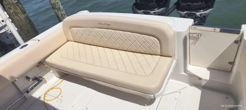 Slide: The Image of 2015 Chris-Craft Catalina 29 boat with beige cushioned seating and dual outboard motors. - 36