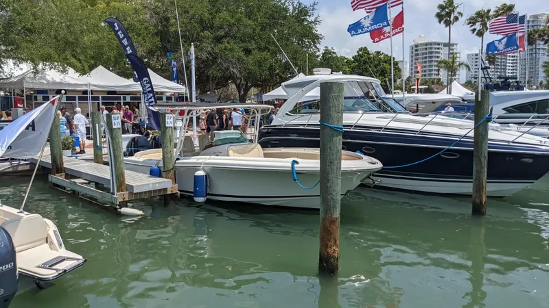 Slide: The Image of 2015 Chris-Craft Catalina 29 docked at a marina during a boat show. - 42