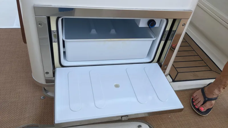 Slide: The Image of Open storage compartment on a 2015 Chris-Craft Catalina 29 boat. - 45