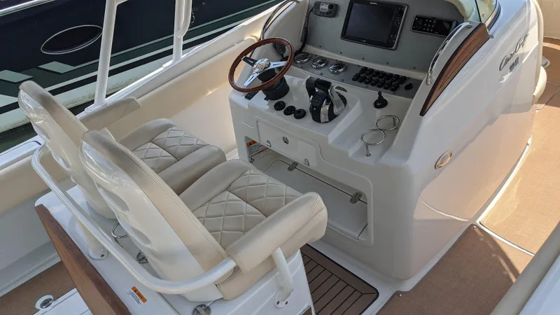 Slide: The Image of 2015 Chris-Craft Catalina 29 boat cockpit with dual seats and modern control panel. - 6