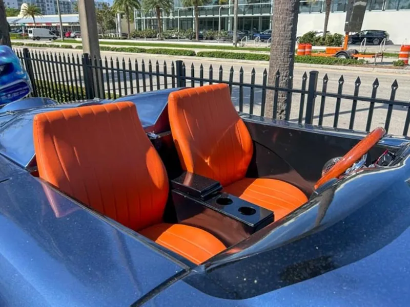 Slide: The Image of 2023 Watersports Car Series M with orange seats and blue exterior. - 3
