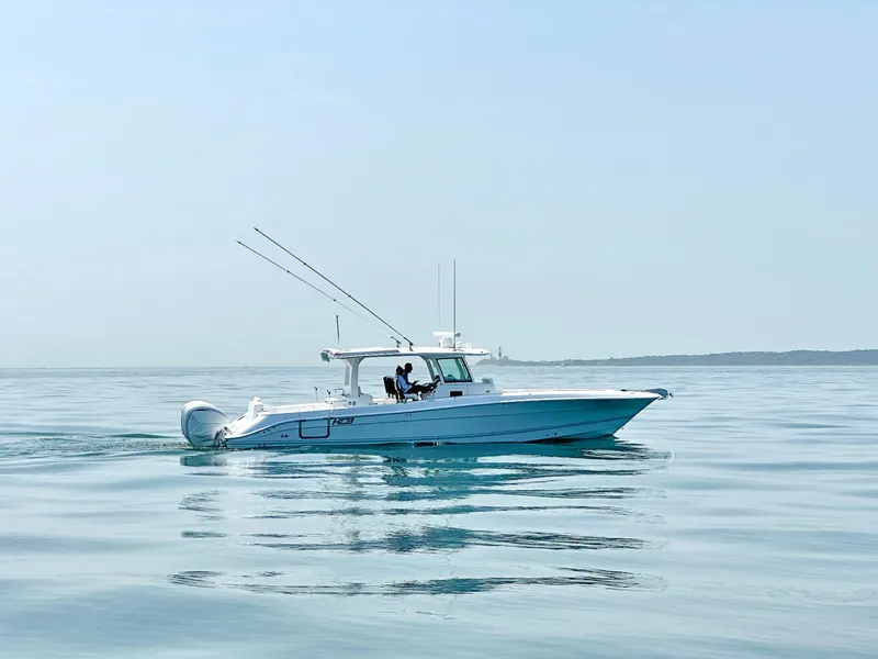 Slide: The Image of 2024 HCB 42 Lujo boat cruising on calm water. - 0