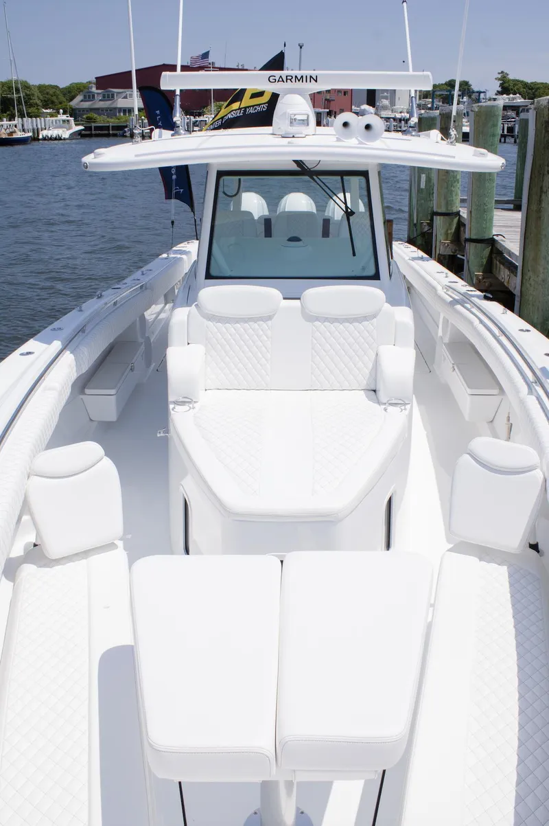 Slide: The Image of 2024 HCB 42 Lujo luxury boat with white seating and advanced navigation system. - 12
