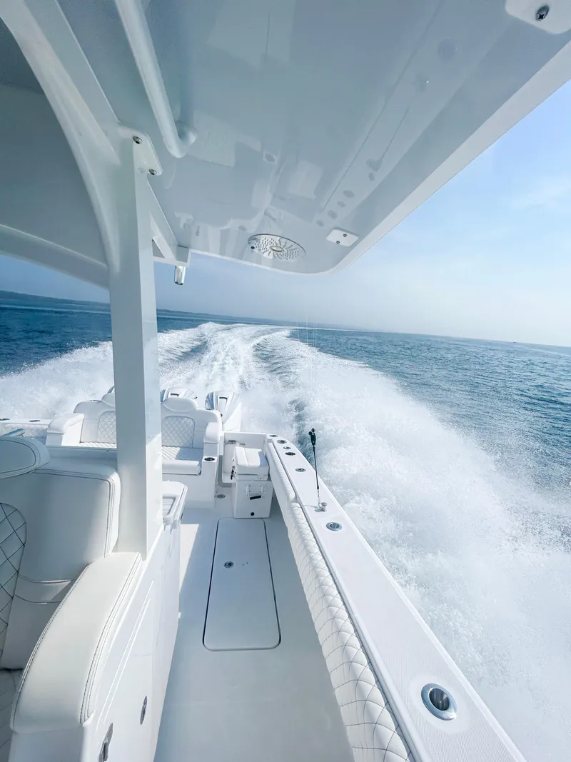 Slide: The Image of 2024 HCB 42 Lujo boat cruising on open water. - 14