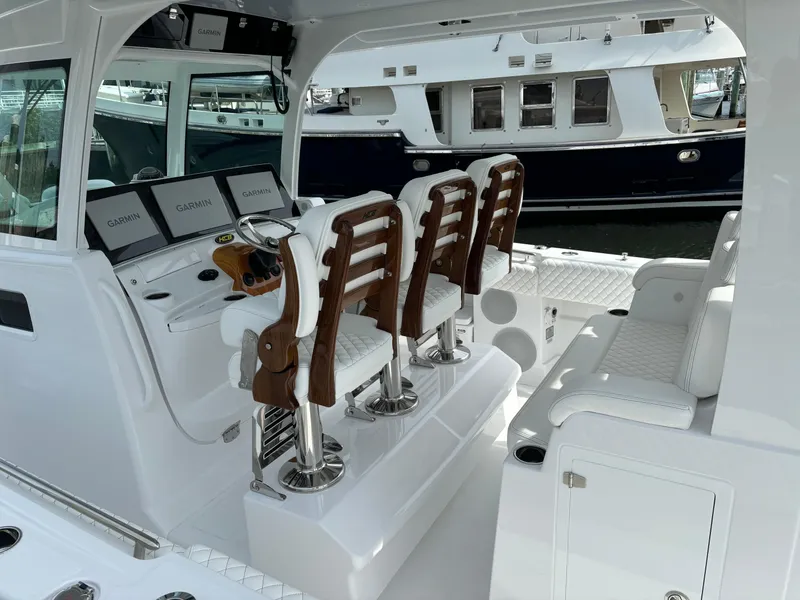 Slide: The Image of 2024 HCB 42 Lujo boat interior with helm seats and navigation screens. - 16