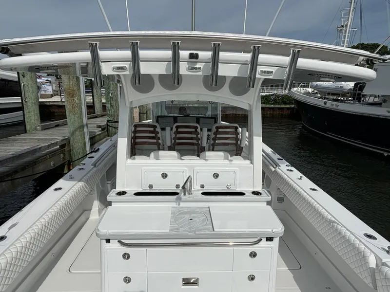 Slide: The Image of 2024 HCB 42 Lujo luxury center console boat docked at marina. - 19