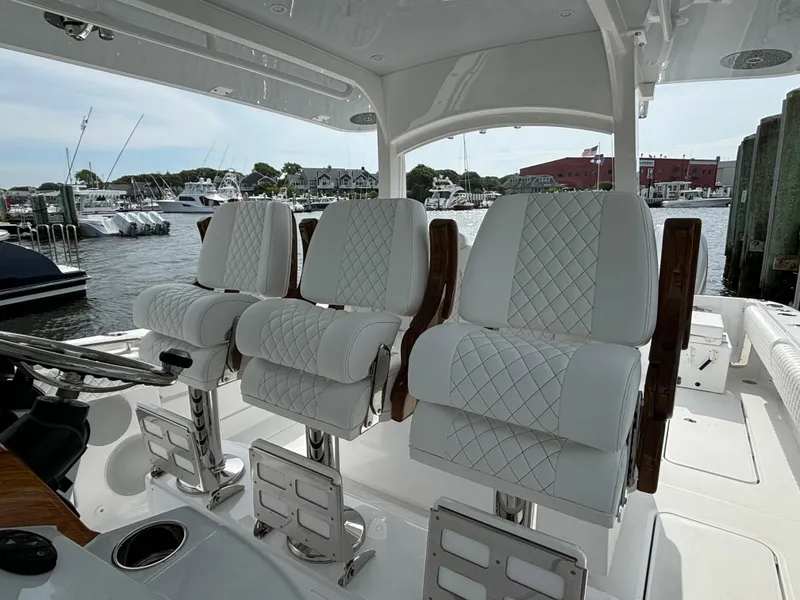 Slide: The Image of 2024 HCB 42 Lujo boat with luxurious white seating at a marina. - 20