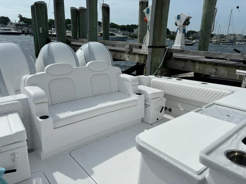 Slide: The Image of 2024 HCB 42 Lujo luxury boat interior with white seating at dock. - 22