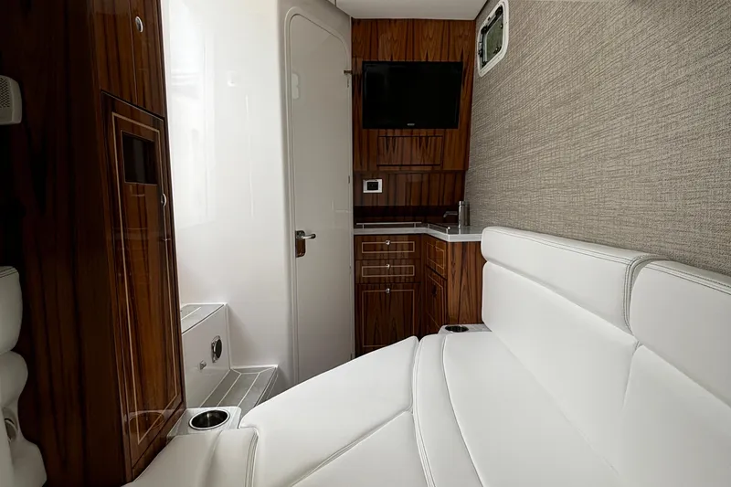 Slide: The Image of Luxurious interior of the 2024 HCB 42 Lujo boat with white seating and wood accents. - 23