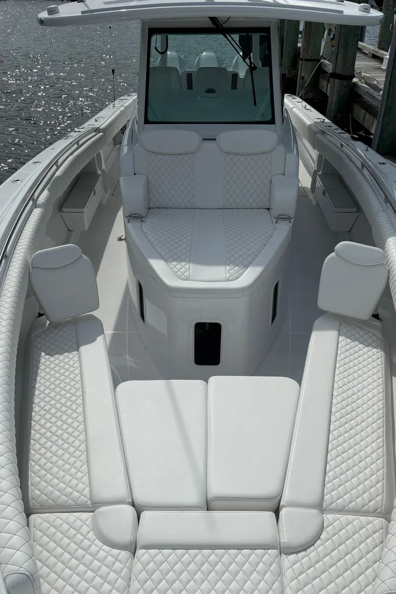 Slide: The Image of 2024 HCB 42 Lujo luxury boat with white quilted seating. - 24