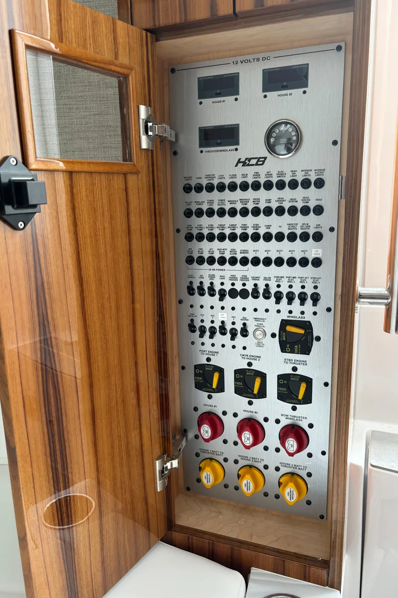 Slide: The Image of Control panel of 2024 HCB 42 Lujo boat with wooden cabinet. - 27