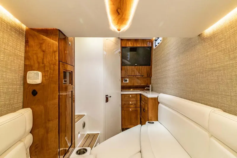 Slide: The Image of Luxurious interior of the 2024 HCB 42 Lujo yacht with wood accents and white seating. - 6