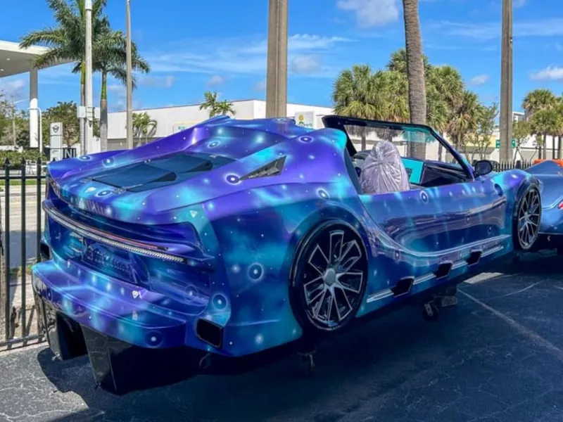 Slide: The Image of 2023 Watersports Car Series B with custom blue and purple paint job. - 2