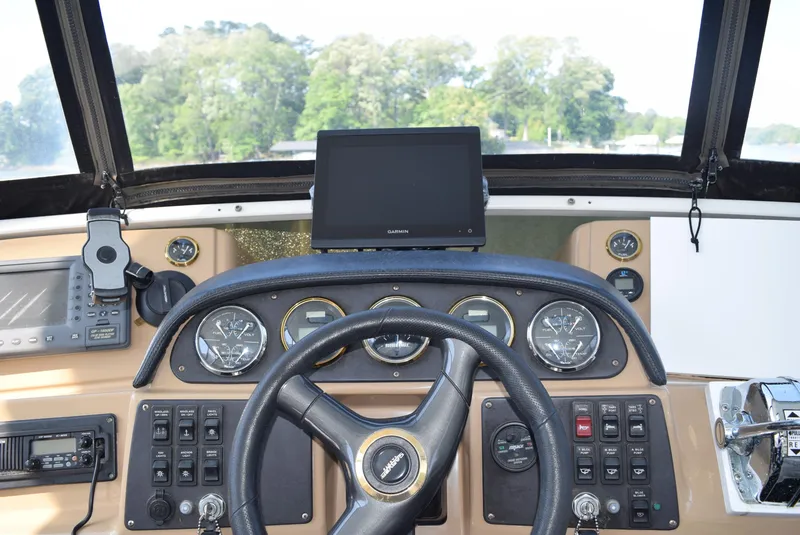 Slide: The Image of 2002 Carver 444 Cockpit Motoryacht helm with navigation equipment and steering wheel. - 10