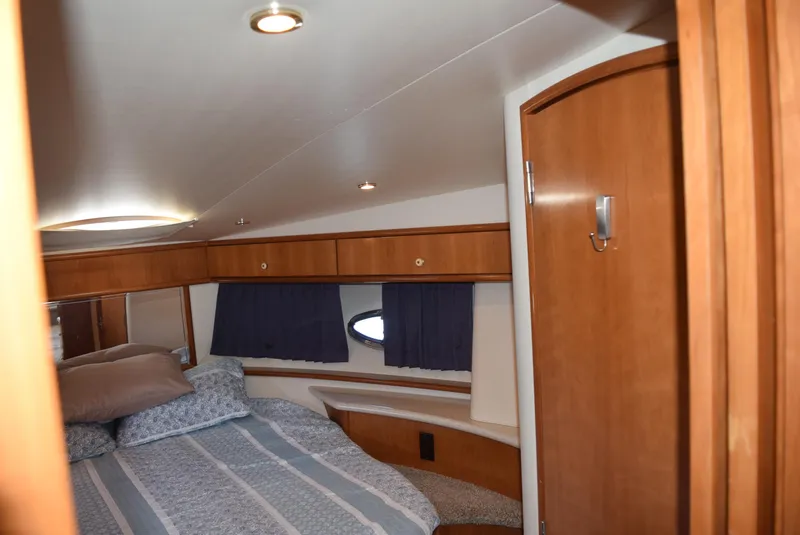 Slide: The Image of Interior cabin of 2002 Carver 444 Cockpit Motoryacht with bed and wooden cabinetry. - 16