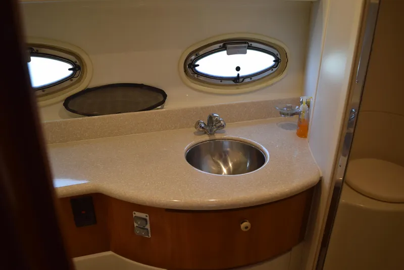 Slide: The Image of Carver 444 Cockpit Motoryacht 2002 bathroom with sink and porthole windows. - 22