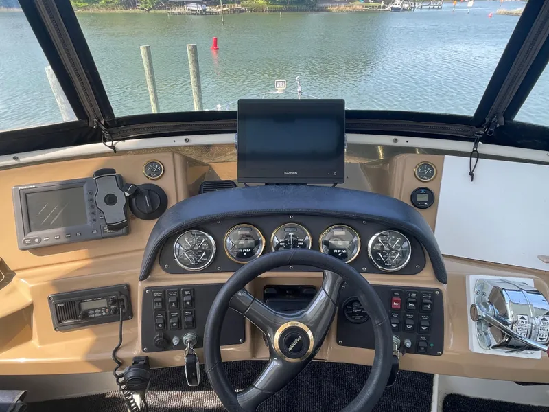 Slide: The Image of Helm of 2002 Carver 444 Cockpit Motoryacht with steering wheel and navigation instruments. - 26