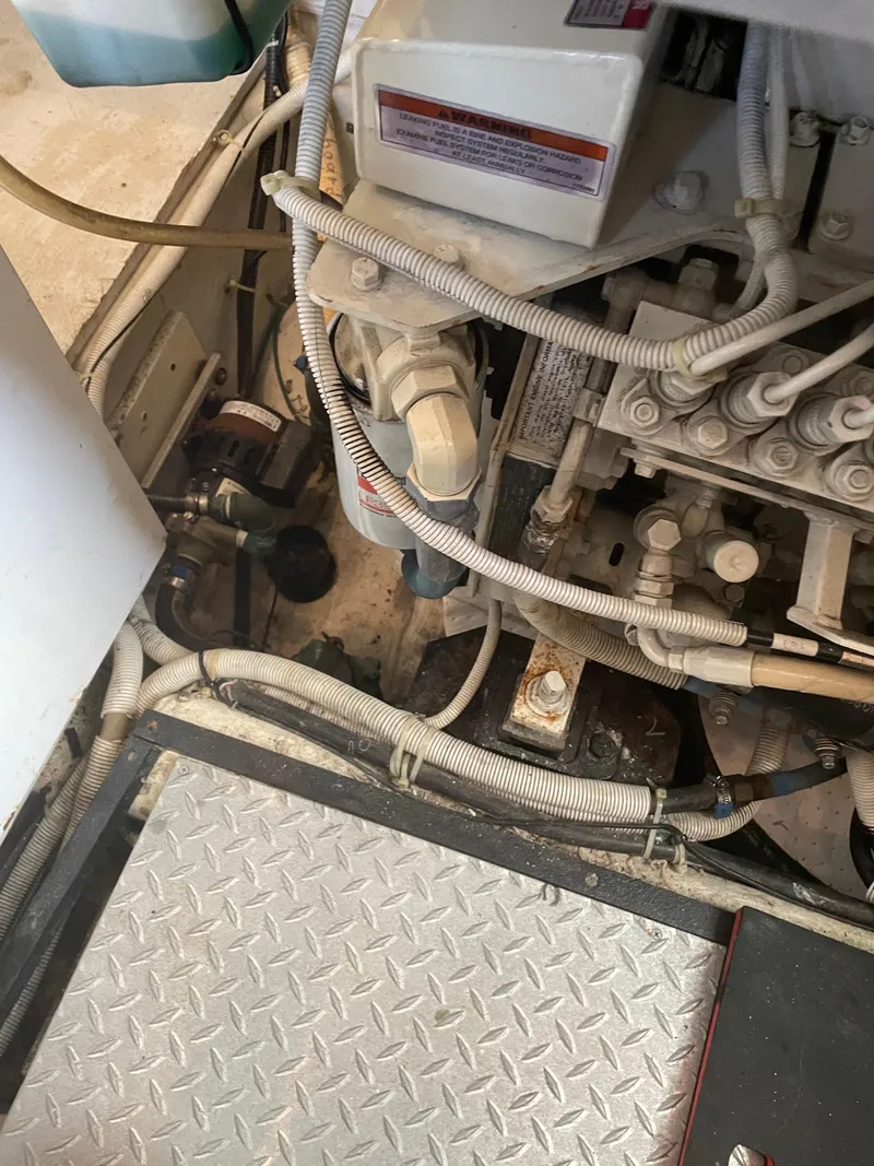 Slide: The Image of Engine compartment of a 2002 Carver 444 Cockpit Motoryacht with visible wiring and components. - 30