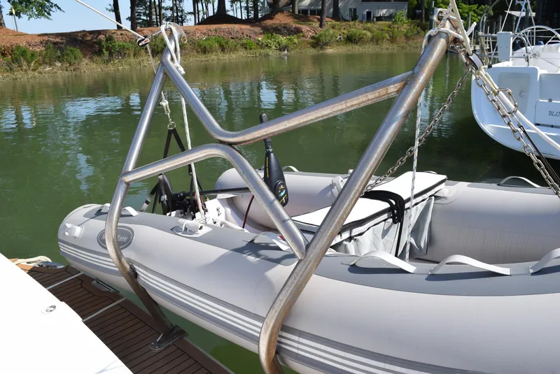 Slide: The Image of Inflatable dinghy on davit system, Carver 444 Cockpit Motoryacht, 2002 model, docked by the water. - 5