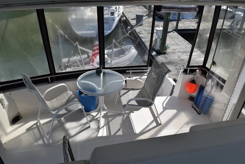 Slide: The Image of 2002 Carver 444 Cockpit Motoryacht interior with seating and table. - 11