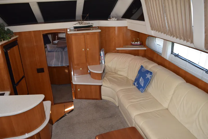 Slide: The Image of Interior of 2002 Carver 444 Cockpit Motoryacht with beige leather seating and wooden cabinetry. - 12