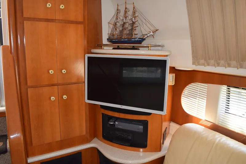 Slide: The Image of Interior of 2002 Carver 444 Cockpit Motoryacht with TV and model ship. - 14