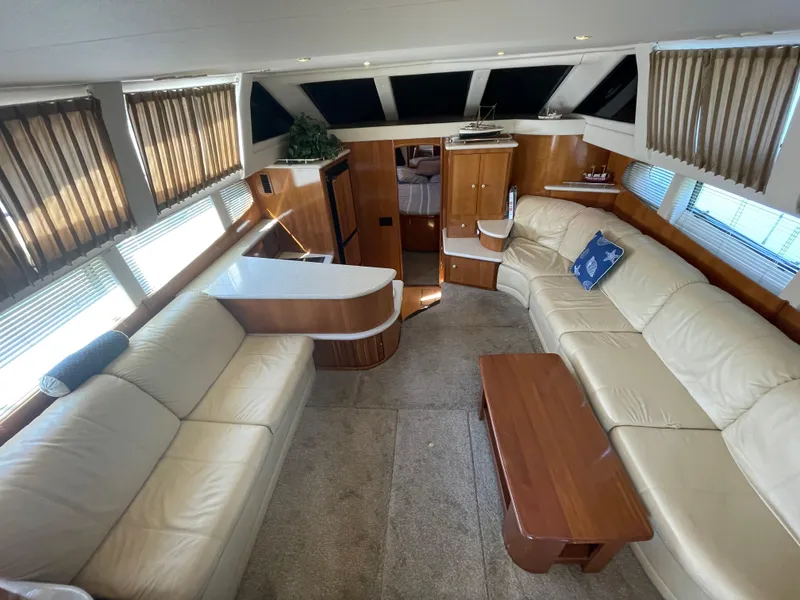 Slide: The Image of Luxurious interior of 2002 Carver 444 Cockpit Motoryacht with cream leather seating and wooden accents. - 28
