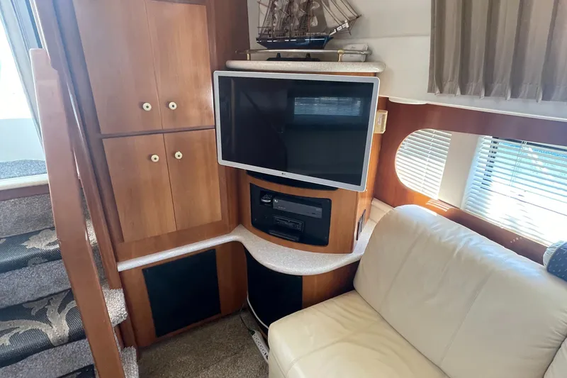 Slide: The Image of Interior of 2002 Carver 444 Cockpit Motoryacht with TV, cabinets, and seating area. - 31