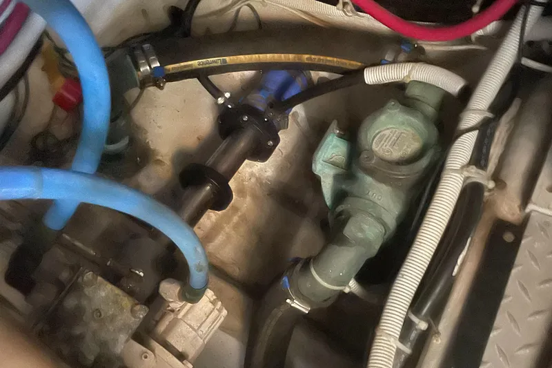 Slide: The Image of Engine compartment of a 2002 Carver 444 Cockpit Motoryacht with various hoses and mechanical components. - 37