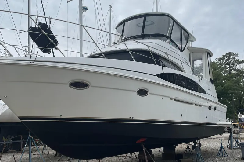 Slide: The Image of 2002 Carver 444 Cockpit Motoryacht on stands in a boatyard. - 43
