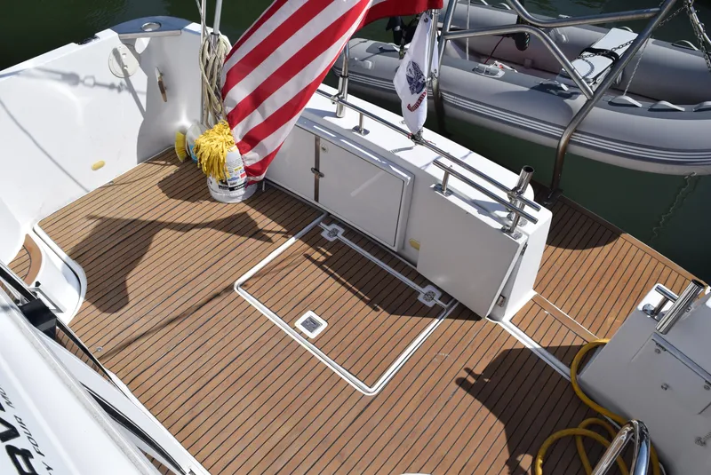 Slide: The Image of 2002 Carver 444 Cockpit Motoryacht deck with American flag and teak flooring. - 6