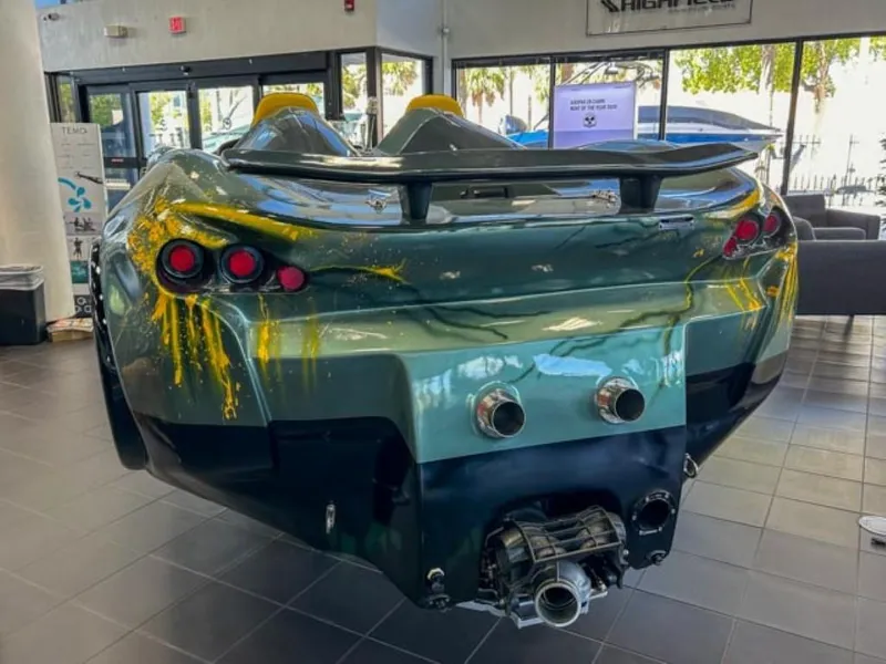 Slide: The Image of 2023 Watersports Car Series X on display, rear view with unique design and dual exhaust. - 2