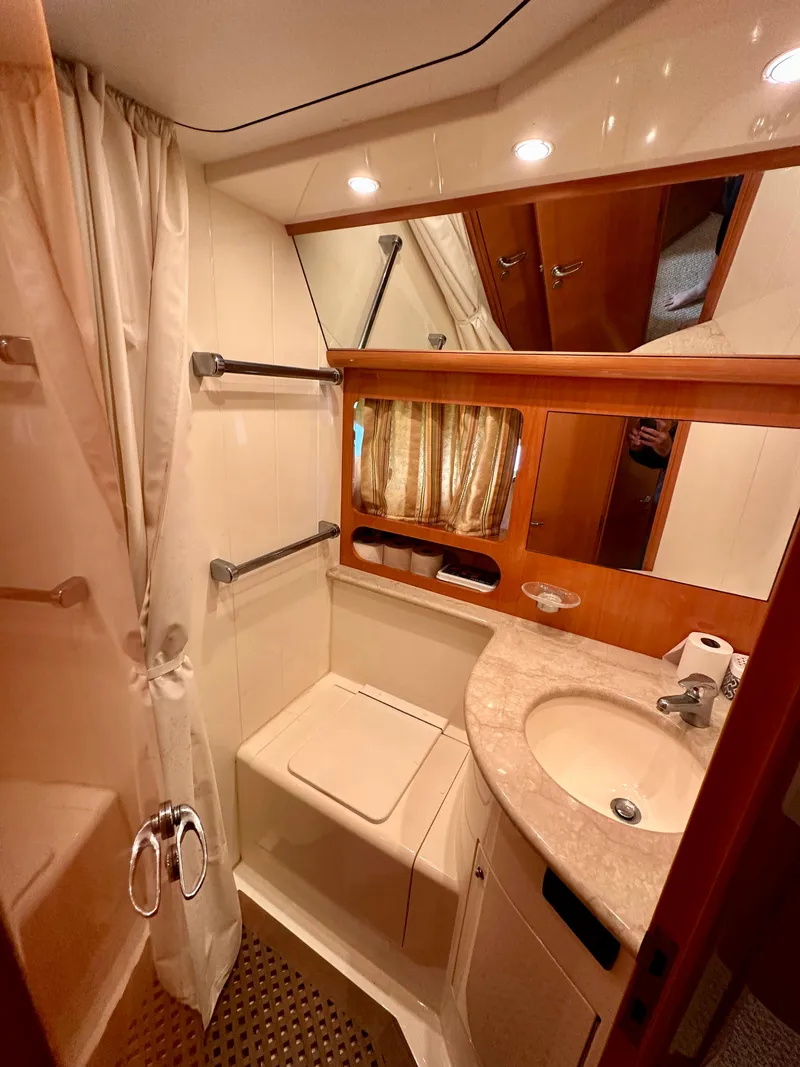 Slide: The Image of 2001 Uniesse 42 Open yacht bathroom with sink, mirror, and shower. - 14