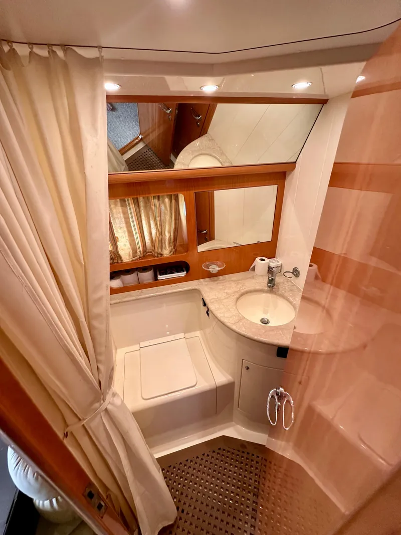 Slide: The Image of 2001 Uniesse 42 Open yacht bathroom with shower, sink, and mirror. - 16