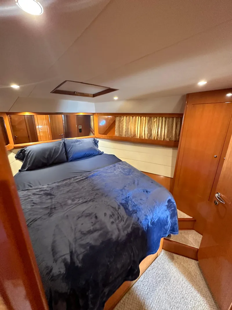 Slide: The Image of Luxurious bedroom in a 2001 Uniesse 42 Open yacht with plush bedding. - 17