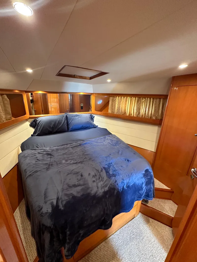 Slide: The Image of Luxurious cabin interior of a 2001 Uniesse 42 Open yacht with a cozy bed. - 19
