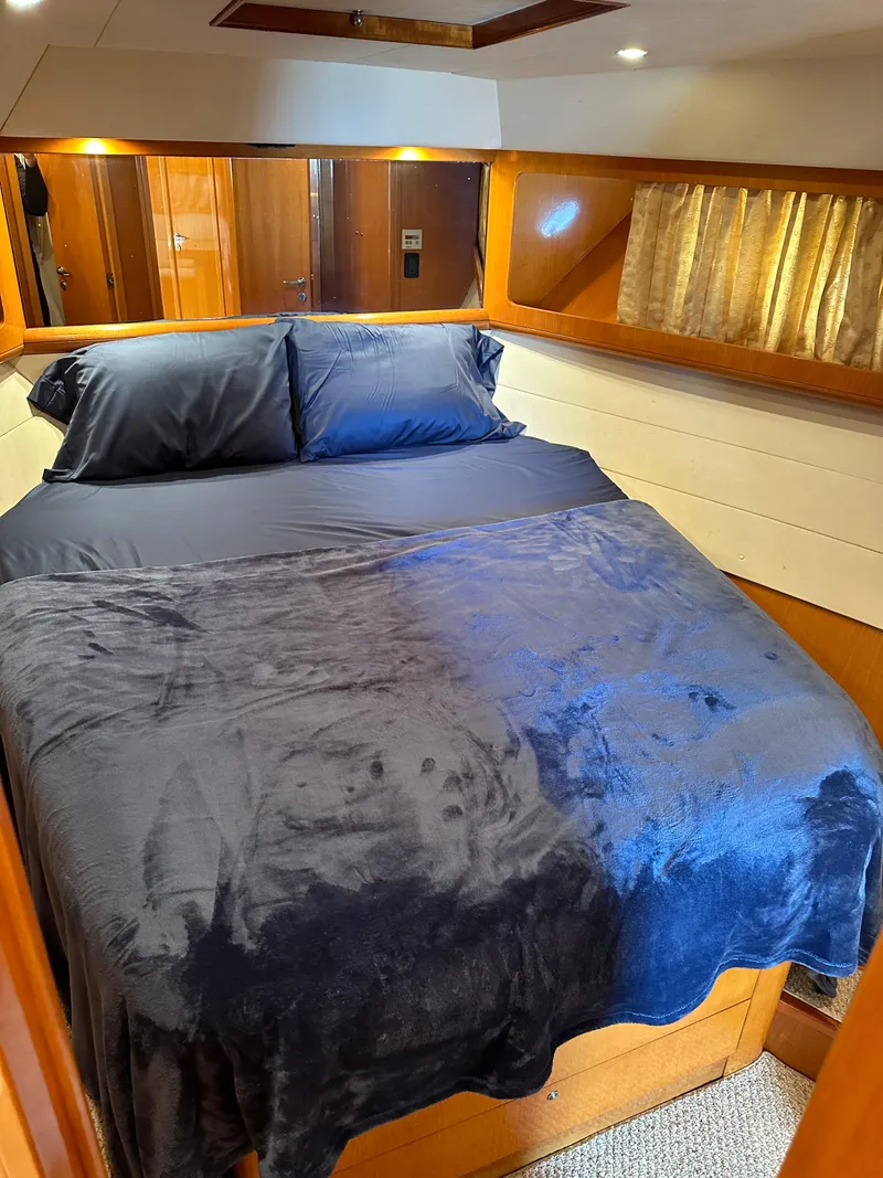 Slide: The Image of Luxurious bedroom interior of a 2001 Uniesse 42 Open yacht with cozy bedding. - 20