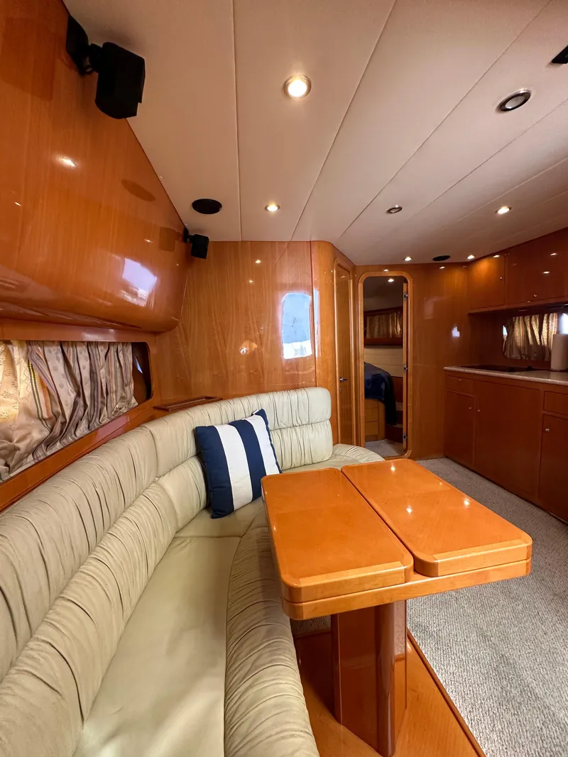 Slide: The Image of Interior of 2001 Uniesse 42 Open yacht with cozy seating and wooden finishes. - 21