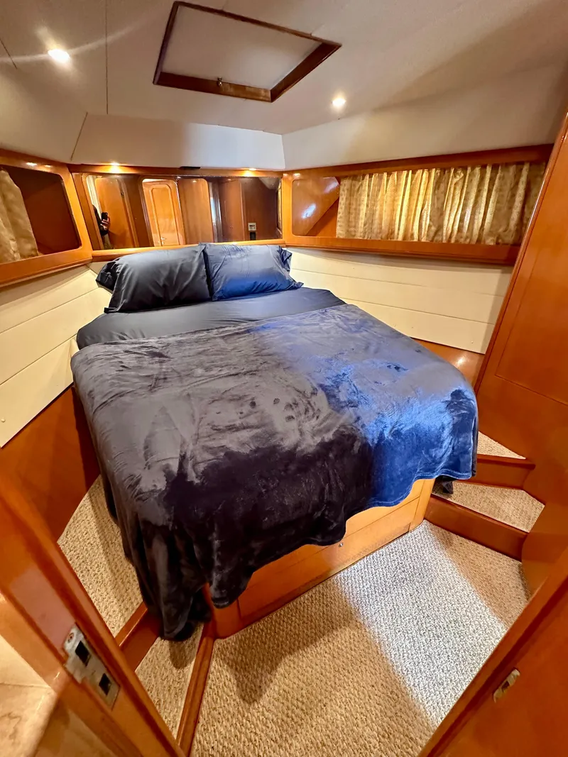 Slide: The Image of Luxurious bedroom interior of 2001 Uniesse 42 Open yacht with cozy bedding. - 22