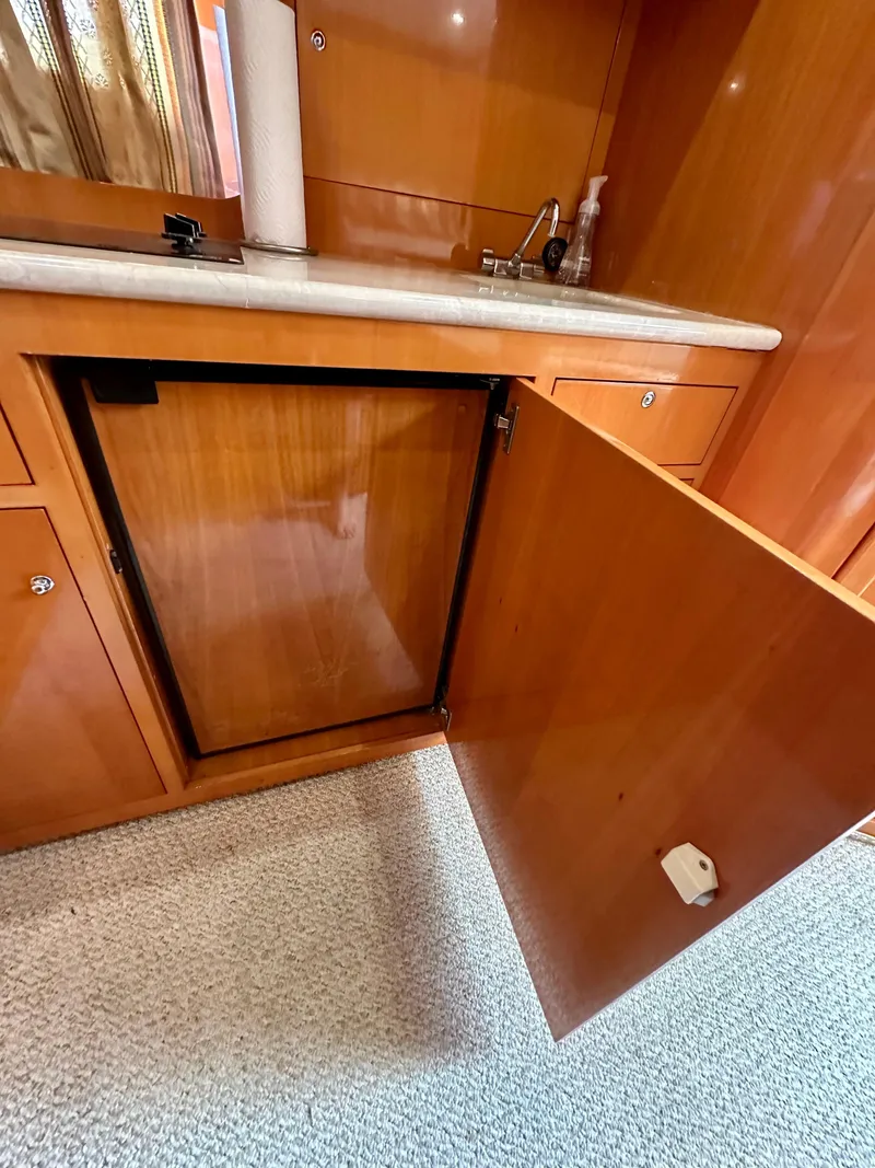 Slide: The Image of Open cabinet in the kitchen area of a 2001 Uniesse 42 Open yacht. - 27