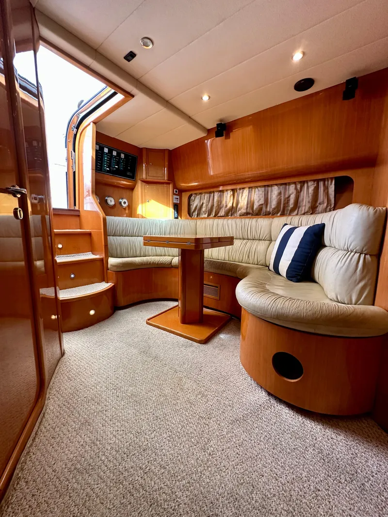 Slide: The Image of Interior of 2001 Uniesse 42 Open yacht with cozy seating and wooden finishes. - 29