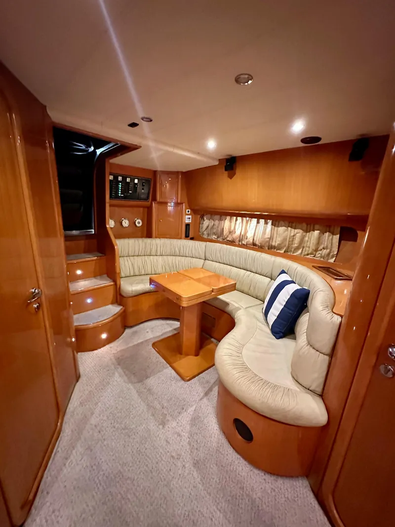 Slide: The Image of 2001 Uniesse 42 Open yacht interior with curved seating and wooden table. - 33