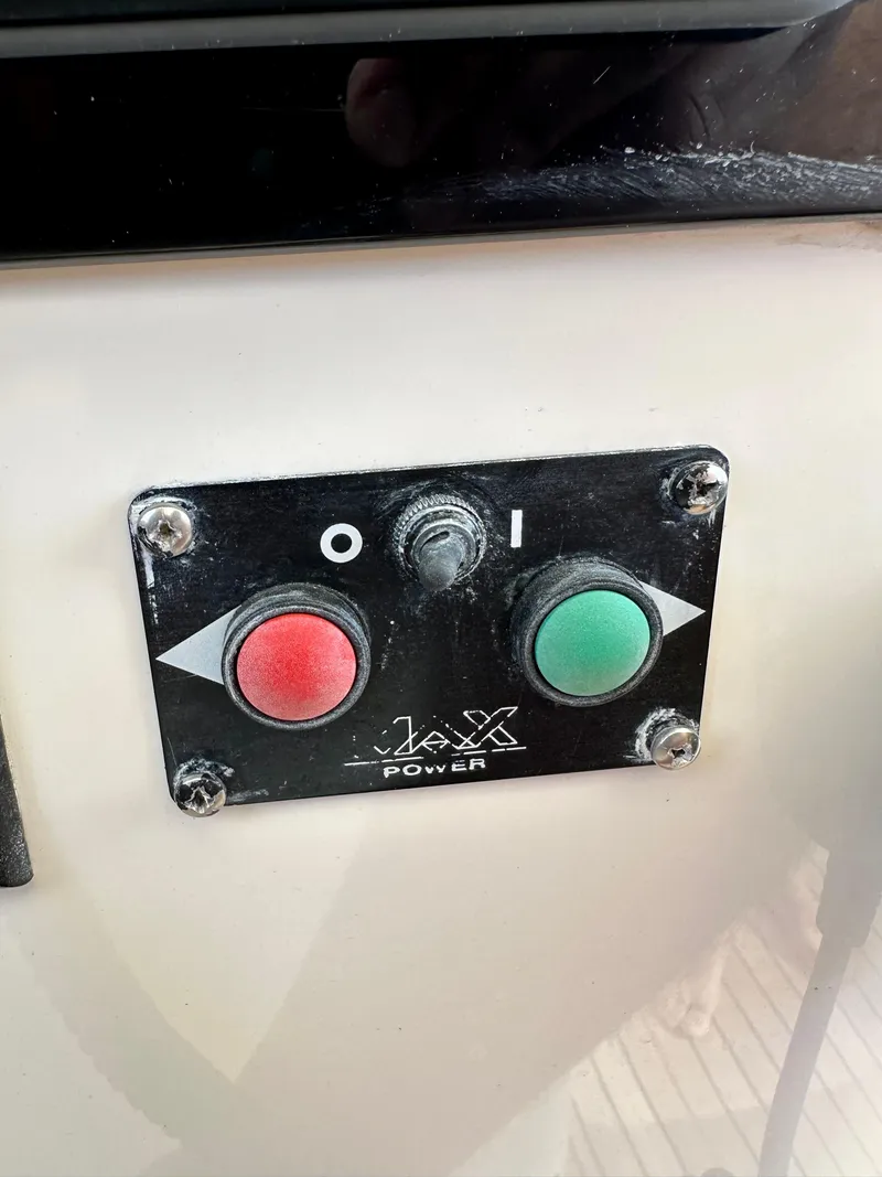 Slide: The Image of Control panel on a 2001 Uniesse 42 Open yacht with power buttons. - 35