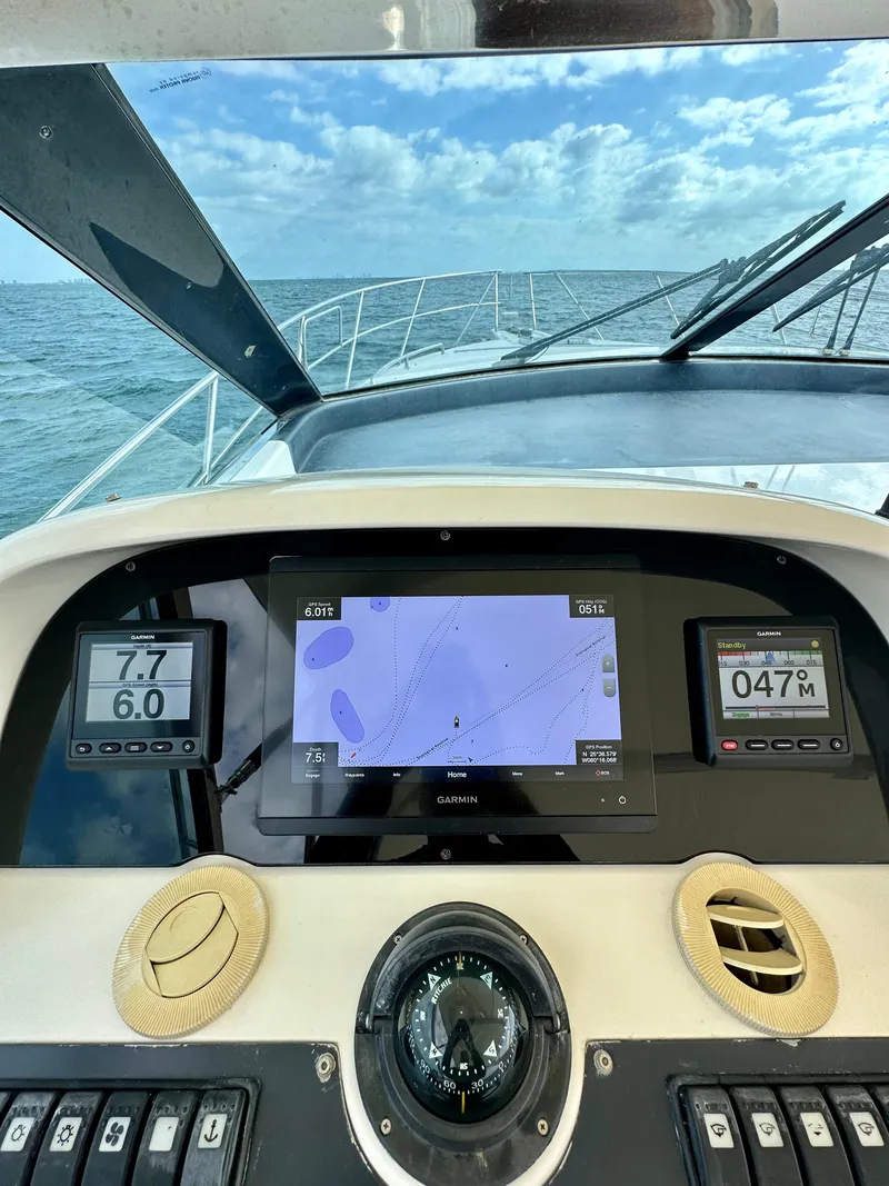 Slide: The Image of Helm of a 2001 Uniesse 42 Open yacht with navigation screens. - 36